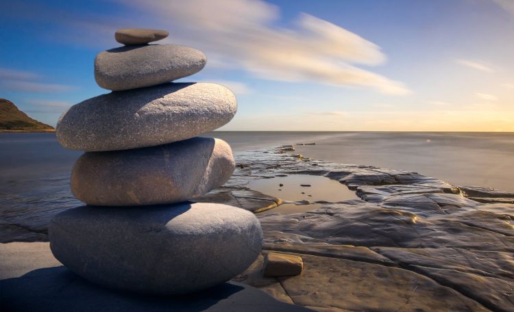Rocks stacked neatly on a beach.