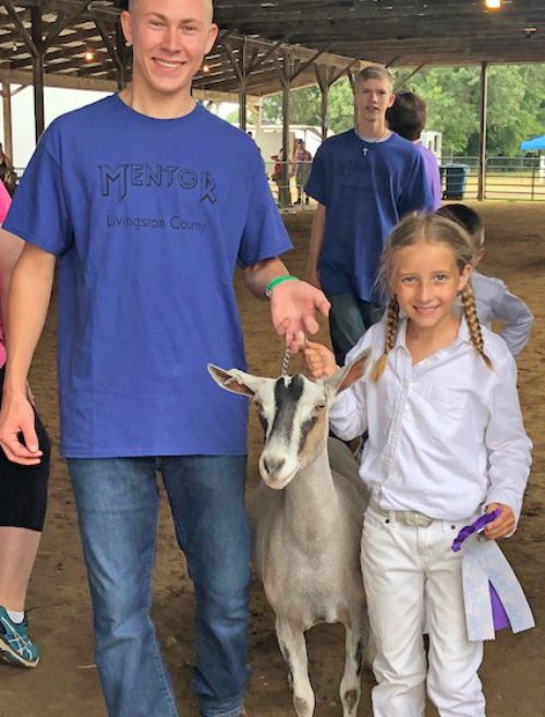 Girl and goat at fair