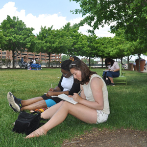 Students sitting in a park at Belle Isle sketching idease for their Student Parks Project
