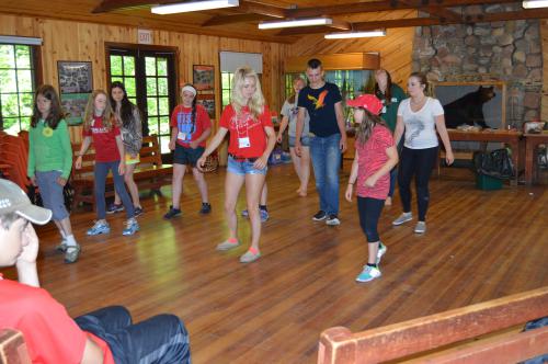 Hannah line dancing with campers