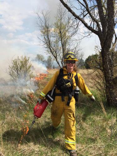 Hilary Wells, igniting a prescribed fire